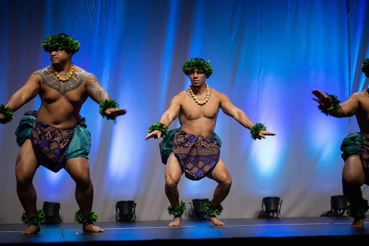 Hawiian dancers perform in traditional costume during an event