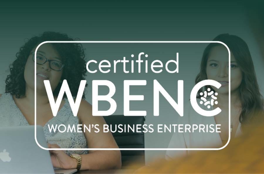 mage with two individuals sitting in background with white lettering reading: “Certified WBENC Women’s Enterprise”